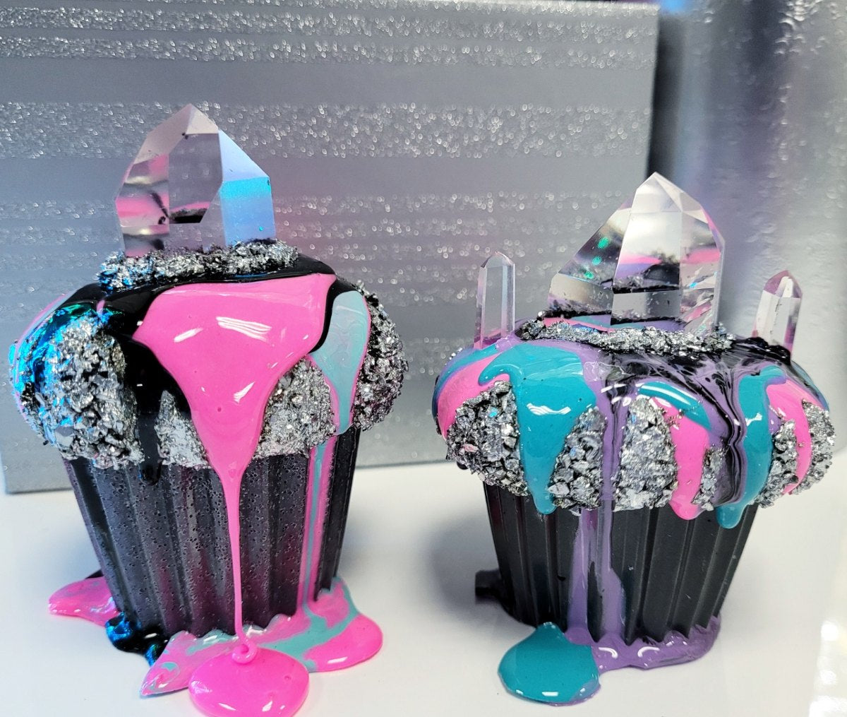 Two GemCake sculptures with pink and teal poured glaze and cut crystal tops