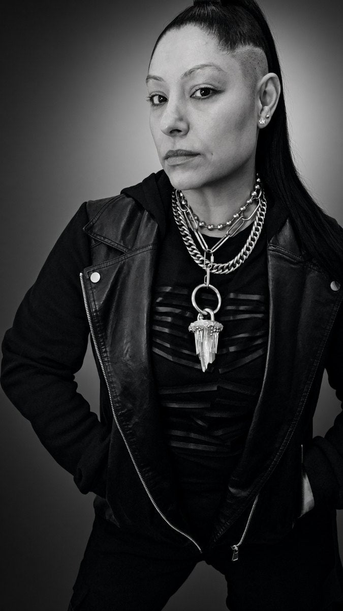 Portrait of Cat Morales, founder and creative director, wearing a hand-cut quartz pendant